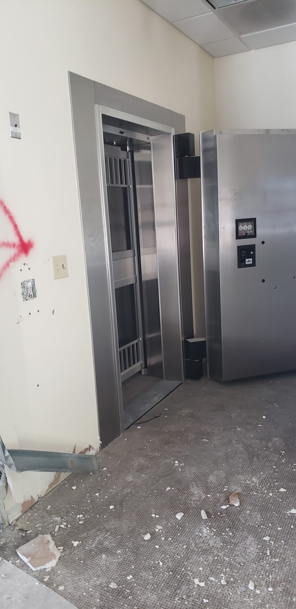 Interior demolition work around a commercial elevator