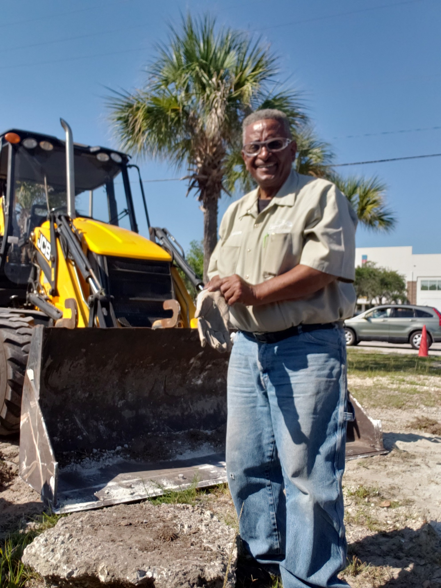 Mr. Watson standing beside Watson demolition equipment