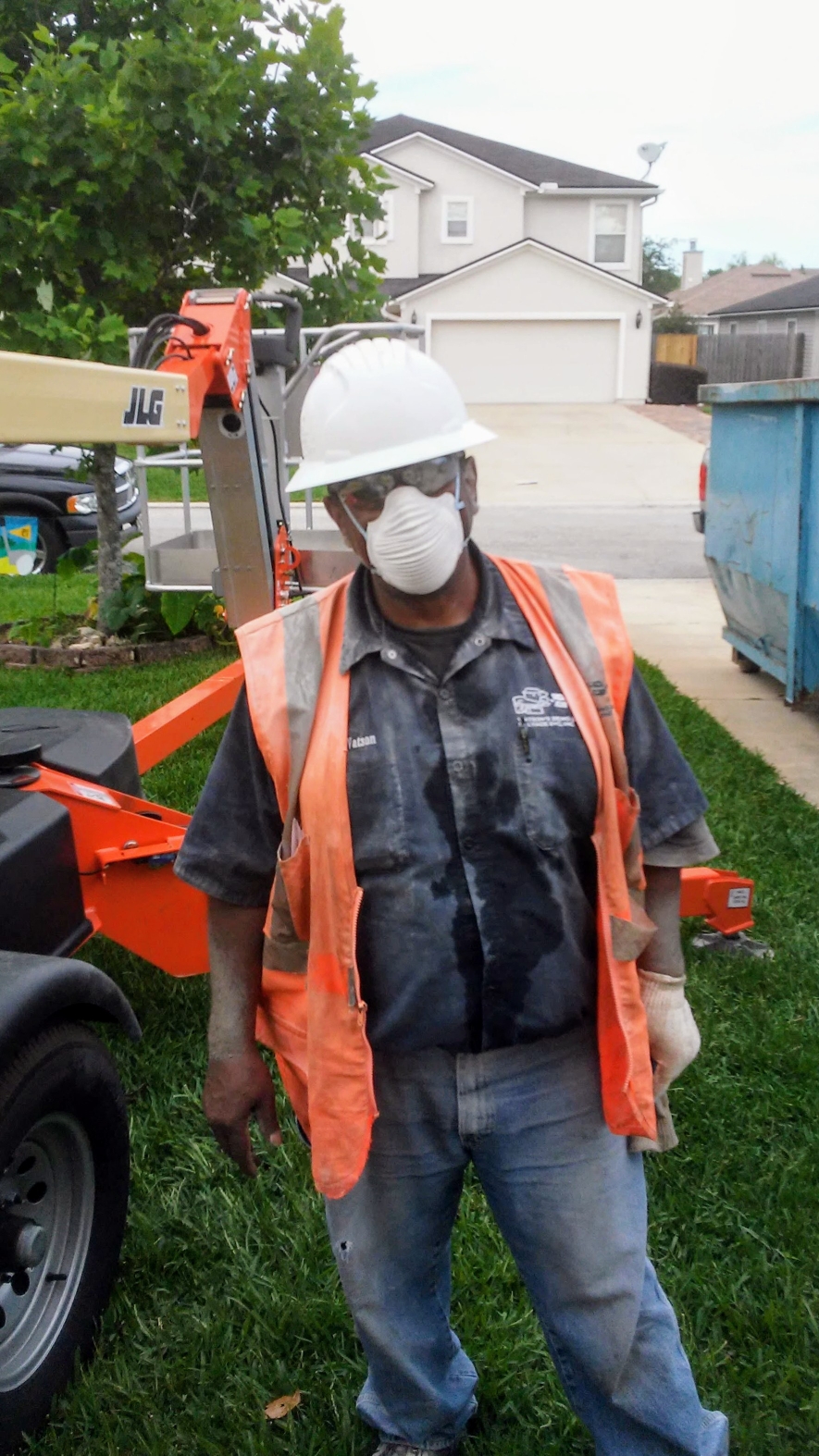 Watson crew member wearing safety equipment at a job site